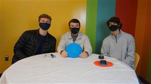 Daniel. Colton, and Sam pose with their invention after the Senior Design showcase